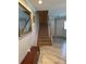 Welcoming entryway with stairs, a mirror, wood floors, and white doors at 1403 Hidden Creek Ln, Winter Haven, FL 33880