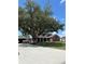 Charming brick home with a covered porch, spacious lawn, mature trees, and a welcoming driveway at 1403 Hidden Creek Ln, Winter Haven, FL 33880