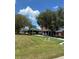 Beautiful home featuring a covered carport, spacious lawn, and mature trees, offering ample parking at 1403 Hidden Creek Ln, Winter Haven, FL 33880