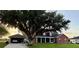 Charming two-story brick home with a covered porch and a lush front lawn at 1403 Hidden Creek Ln, Winter Haven, FL 33880
