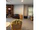 Inviting living room with a ceiling fan, carpet, built-in shelving, and comfortable seating at 1403 Hidden Creek Ln, Winter Haven, FL 33880