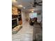Comfortable living room with stone fireplace, built-in shelving, and views into the dining area at 1403 Hidden Creek Ln, Winter Haven, FL 33880
