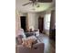 Cozy living room featuring wood floors, a ceiling fan, and neutral tones at 1403 Hidden Creek Ln, Winter Haven, FL 33880