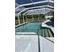 Backyard pool with a screened enclosure and a view of the surrounding landscape at 1403 Hidden Creek Ln, Winter Haven, FL 33880
