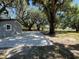 Expansive backyard with mature trees providing ample shade for relaxation and outdoor activities at 180 Old Connersville Rd, Bartow, FL 33830