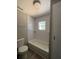 Updated bathroom features subway tile shower, new toilet, and new flooring at 180 Old Connersville Rd, Bartow, FL 33830