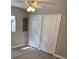 Bright bedroom features a ceiling fan, wood-look flooring, and closet doors at 180 Old Connersville Rd, Bartow, FL 33830