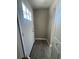Bright entryway with new gray flooring and a storm door at 180 Old Connersville Rd, Bartow, FL 33830