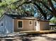 Charming exterior of a well-maintained home, featuring a new wooden deck perfect for outdoor relaxation at 180 Old Connersville Rd, Bartow, FL 33830