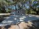 Charming exterior of a cozy home, surrounded by mature trees and a large, spacious driveway at 180 Old Connersville Rd, Bartow, FL 33830