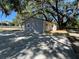 Exterior view of a home with a deck, with mature trees providing a serene and picturesque setting at 180 Old Connersville Rd, Bartow, FL 33830