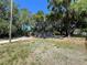 Cozy cottage-style home nestled among mature oak trees and manicured landscaping at 180 Old Connersville Rd, Bartow, FL 33830