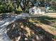 House with a concrete driveway surrounded by grass and trees at 180 Old Connersville Rd, Bartow, FL 33830