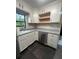 Well-lit kitchen featuring shaker style cabinets, stainless appliances, and dark flooring at 180 Old Connersville Rd, Bartow, FL 33830