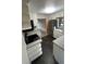 Updated kitchen featuring stainless steel appliances, white cabinets, and dark tile floors at 180 Old Connersville Rd, Bartow, FL 33830