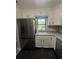 Updated kitchen features a stainless steel refrigerator, a window over sink, and white cabinets at 180 Old Connersville Rd, Bartow, FL 33830