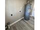 Bright laundry room features wood-look flooring, water heater and hookups at 180 Old Connersville Rd, Bartow, FL 33830