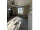Sunlit living room featuring modern gray flooring and neutral paint at 180 Old Connersville Rd, Bartow, FL 33830