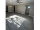 Spacious living room featuring gray wood flooring and new interior paint at 180 Old Connersville Rd, Bartow, FL 33830