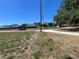 Street view of a lot featuring mature trees and utility infrastructure in a residential area at 180 Old Connersville Rd, Bartow, FL 33830