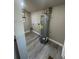 Utility room featuring luxury vinyl plank flooring and a modern water heater at 180 Old Connersville Rd, Bartow, FL 33830