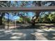 A clear view to the expansive yard, filtered through mature trees at 180 Old Connersville Rd, Bartow, FL 33830