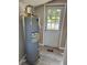 Hot water tank with easy access, situated near an exit for convenience and potential outdoor access at 180 Old Connersville Rd, Bartow, FL 33830