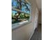 A bright window offering views of the outdoors and mature trees at 180 Old Connersville Rd, Bartow, FL 33830
