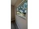 A bright window offering views of the outdoors and mature trees at 180 Old Connersville Rd, Bartow, FL 33830
