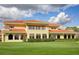 Expansive lawn with red tiled roof and upper balcony provides panoramic views of the golf course at 1942 Bermuda Pointe Dr, Haines City, FL 33844