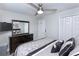 Comfortable bedroom with a large window, ceiling fan, dark wood furniture, and a closet at 1942 Bermuda Pointe Dr, Haines City, FL 33844
