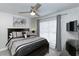 Cozy bedroom with a large window, ceiling fan, and dark wood furniture at 1942 Bermuda Pointe Dr, Haines City, FL 33844
