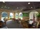 The dining area offers a relaxing view with large arched windows overlooking the lush greens and fairways of the golf course at 1942 Bermuda Pointe Dr, Haines City, FL 33844