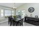 Inviting dining room with large windows, vaulted ceiling, stylish furniture, and a buffet at 1942 Bermuda Pointe Dr, Haines City, FL 33844