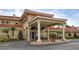 Inviting entrance featuring a portico with stately columns, manicured landscaping, and a terracotta-tiled roof at 1942 Bermuda Pointe Dr, Haines City, FL 33844