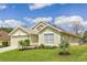 Charming single-story home featuring lush green lawn and well-manicured landscaping at 1942 Bermuda Pointe Dr, Haines City, FL 33844