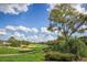 Beautifully landscaped golf course view showcasing lush greens, sand traps, and mature trees at 1942 Bermuda Pointe Dr, Haines City, FL 33844