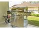 The covered patio has a stainless steel natural gas grill with six burners at 1942 Bermuda Pointe Dr, Haines City, FL 33844