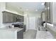 Modern kitchen with tile floors, stainless appliances, stone countertops, and ample storage at 1942 Bermuda Pointe Dr, Haines City, FL 33844