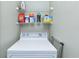 The laundry room shows a white washing machine under an overhead storage rack at 1942 Bermuda Pointe Dr, Haines City, FL 33844