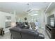 Bright living room boasts vaulted ceiling, fan, tile floors, and comfortable leather seating at 1942 Bermuda Pointe Dr, Haines City, FL 33844
