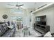 Open living room with high ceiling, tile floors, TV, modern furnishings and patio access at 1942 Bermuda Pointe Dr, Haines City, FL 33844