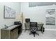 Well-lit home office featuring tiled floors, a modern desk, and decorative artwork at 1942 Bermuda Pointe Dr, Haines City, FL 33844