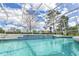 Inviting screened-in pool area features a sparkling pool and ample lounge seating at 1942 Bermuda Pointe Dr, Haines City, FL 33844