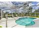 Inviting screened-in pool area features a sparkling pool and ample lounge seating at 1942 Bermuda Pointe Dr, Haines City, FL 33844
