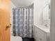 Bathroom featuring white vanity and shower with a blue floral curtain at 2055 S Floral Ave # 42, Bartow, FL 33830