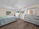 Bright bedroom features wood floors, ceiling fan, and large dresser with mirrored accents at 2055 S Floral Ave # 42, Bartow, FL 33830