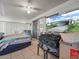 Bedroom area includes a ceiling fan, TV, and access to a patio at 2055 S Floral Ave # 42, Bartow, FL 33830