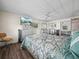 Bedroom features wood floors, a ceiling fan, and sliding door closet at 2055 S Floral Ave # 42, Bartow, FL 33830