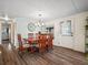 Dining room with wood floors, table, six chairs, and natural light at 2055 S Floral Ave # 42, Bartow, FL 33830